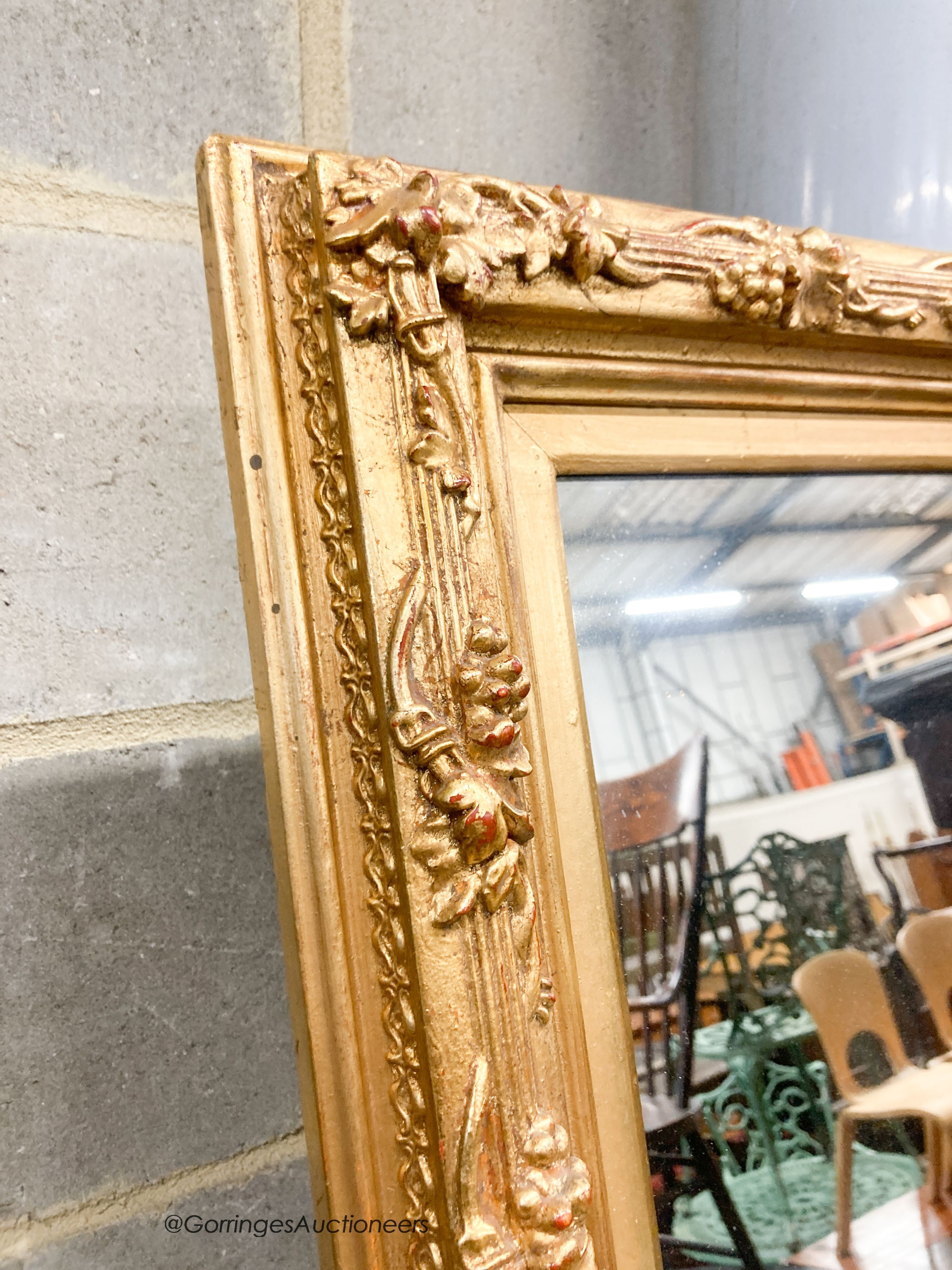 A rectangular carved giltwood framed wall mirror, width 67cm, height 132cm